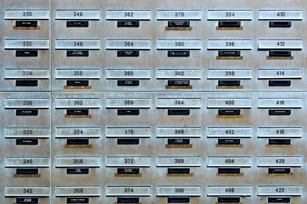 Rows of numbered industrial metal mailboxes